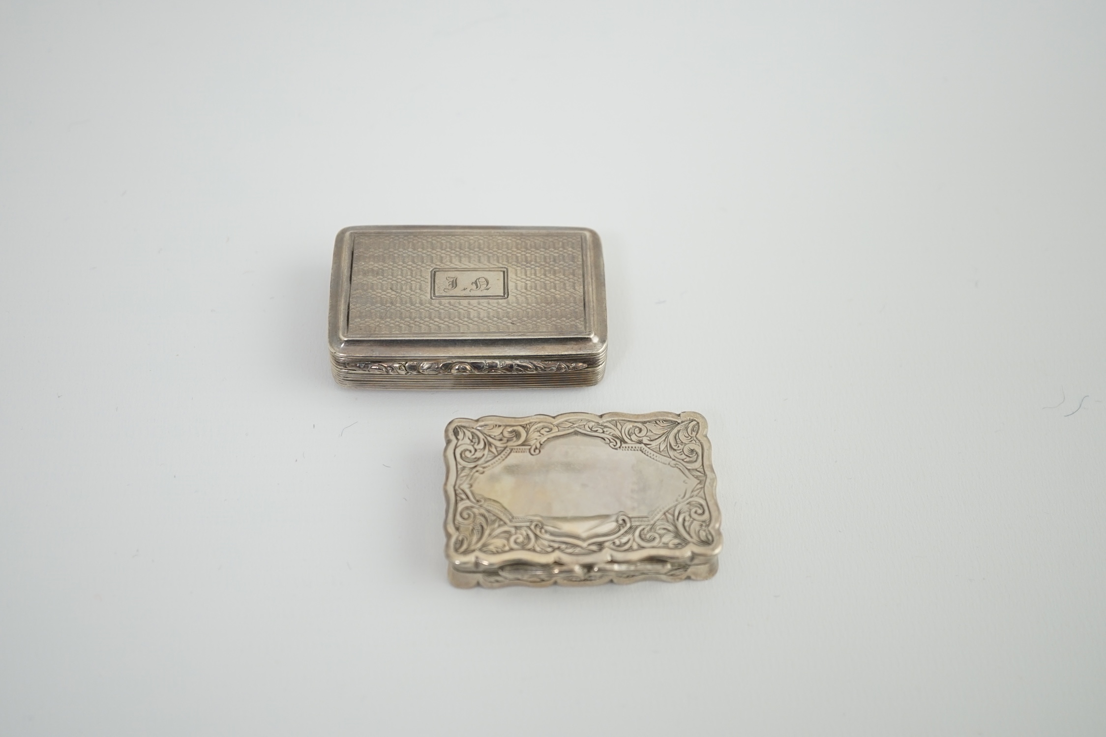 A George IV silver snuff box, with engraved initials, Thomas Shaw?, Birmingham, 1826, 54mm, together with a Victorian silver snuff box, George Unite, Birmingham, 1875.